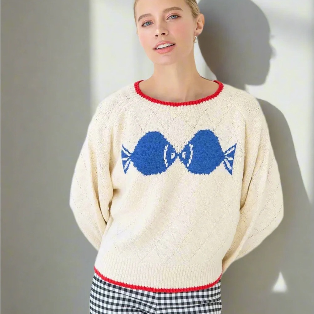 Cream Crewneck Sweater with Blue Bow Motif and Red Trim